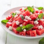 fresh-watermelon-salad-with-feta-cheese-mint-leaves-white-plate_9975-124546