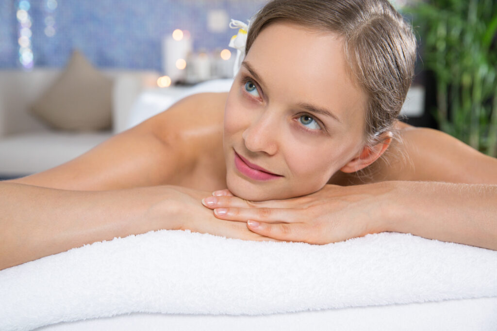 Attractive Woman Lying on Massage Table in Spa