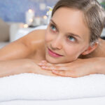 Attractive Woman Lying on Massage Table in Spa