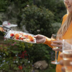 side-view-smiley-woman-holding-tray-with-food