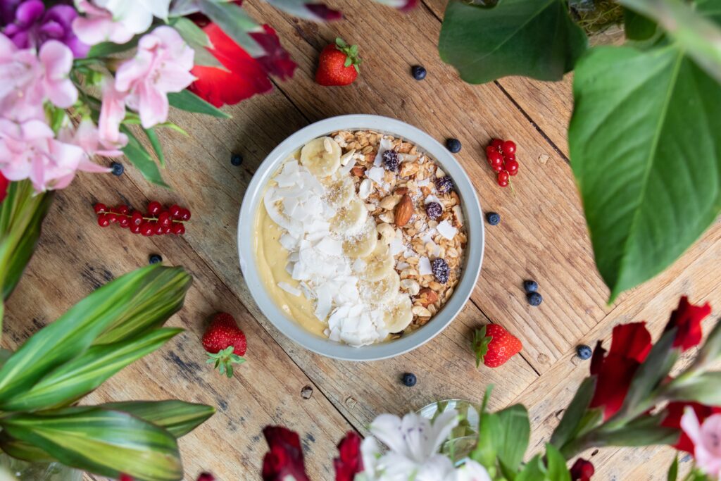 Top view of a healthy smoothie bowl with fruits and granola