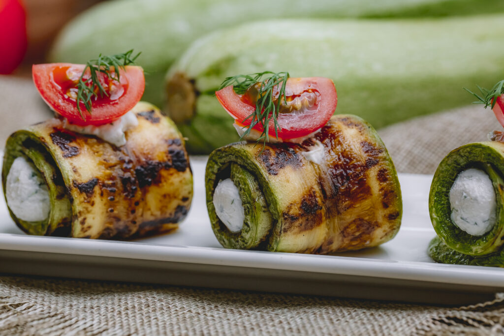 zucchini roll with cream cheese greens tomato dill side view