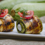 zucchini roll with cream cheese greens tomato dill side view